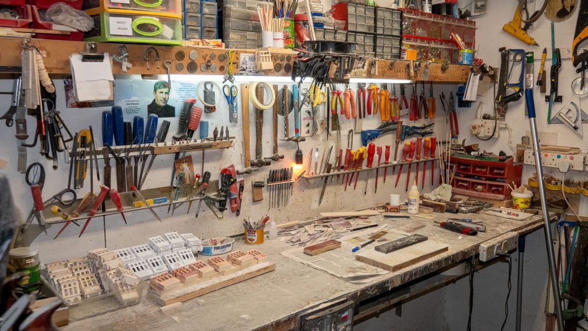 A toolbox and notepad on a workbench