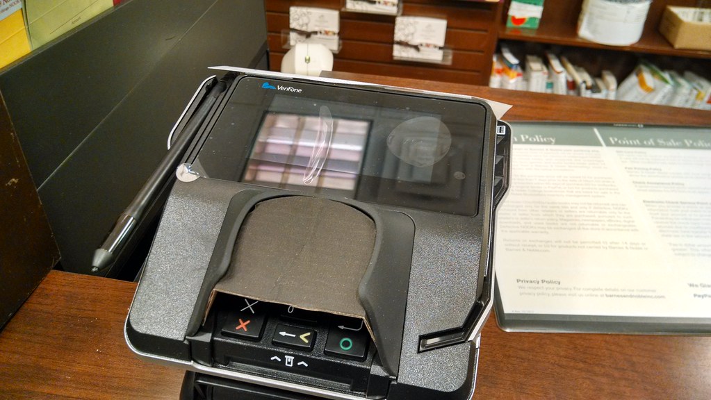 A person paying at a card terminal
