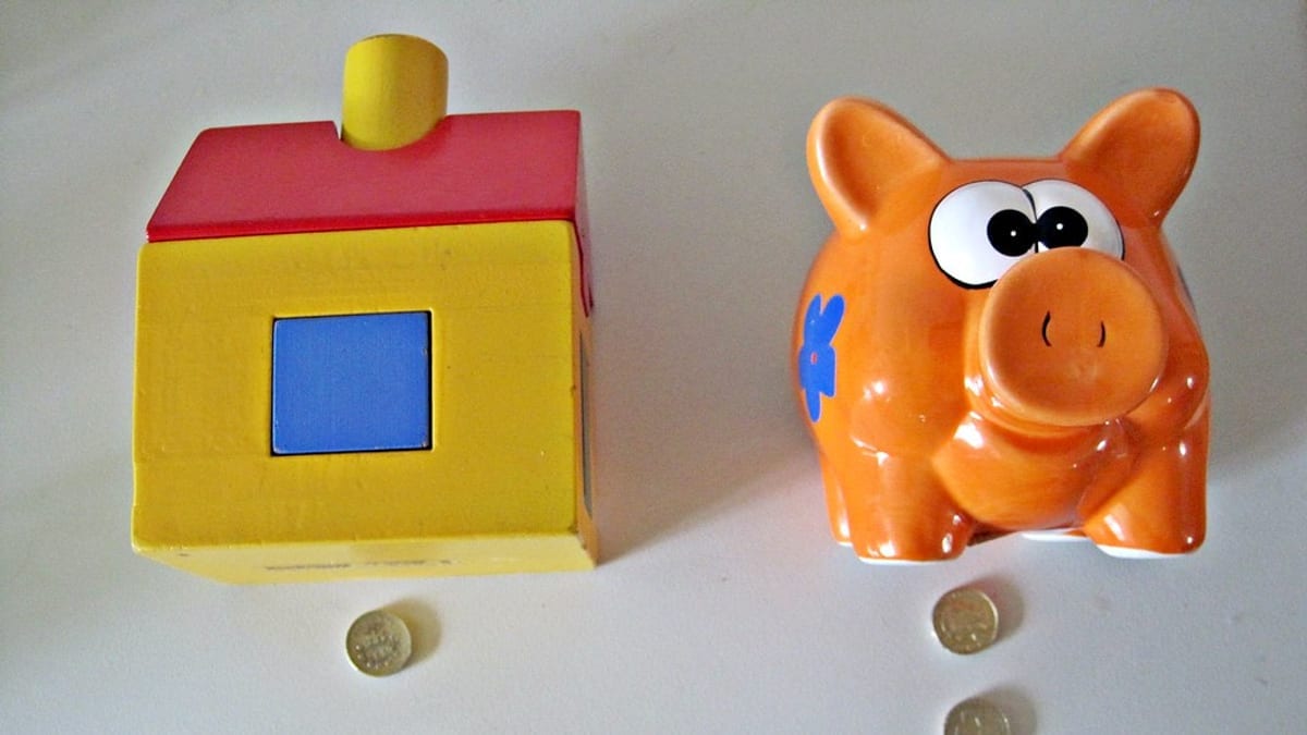 A model house beside coins