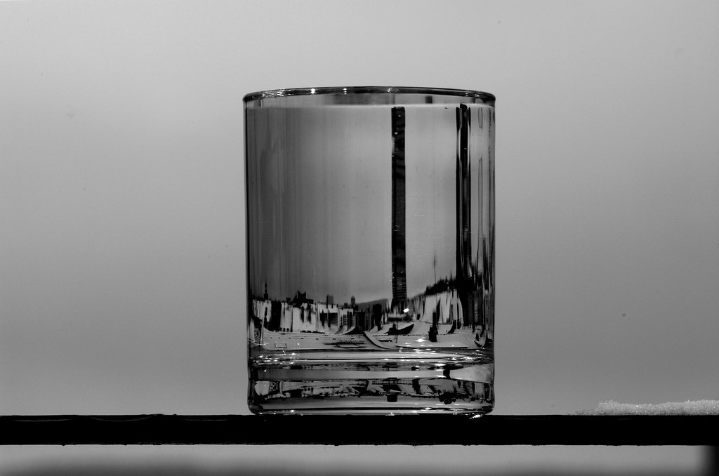 A glass of water on a table in natural light