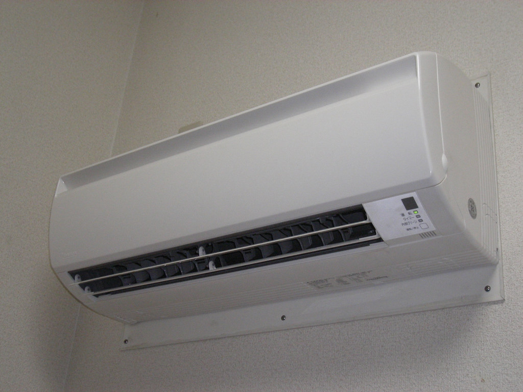 A wall-mounted air conditioning unit in a living room