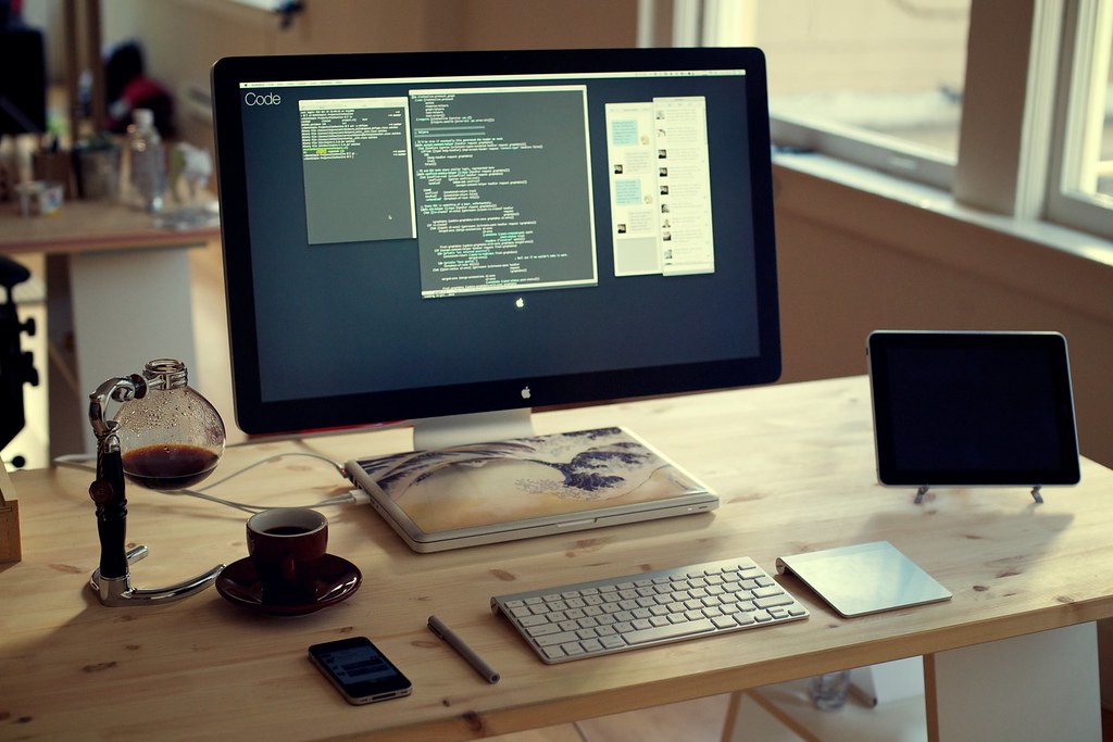 Coffee cup beside an open laptop