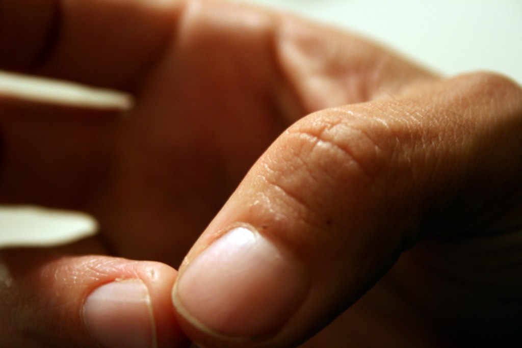 Hands crocheting with a hook and yarn