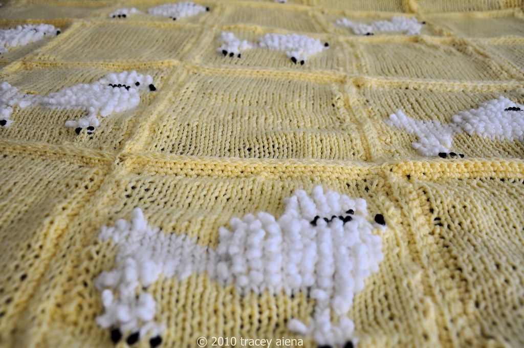 A crochet pattern printed on paper beside a hook
