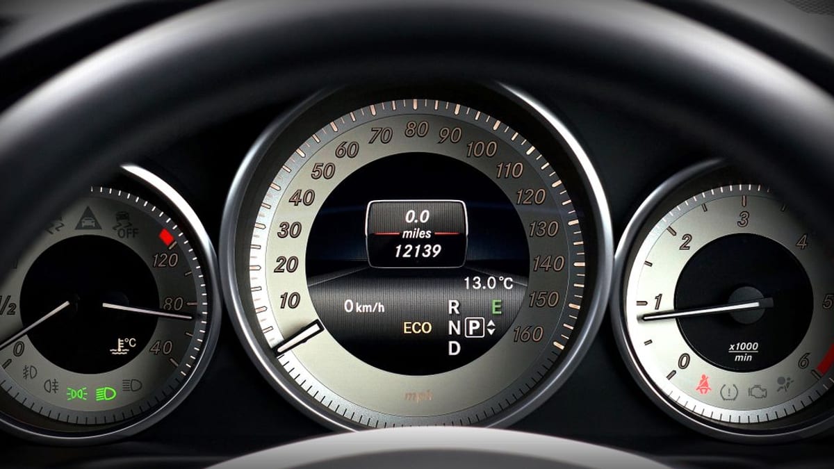 A car dashboard and steering wheel in daylight